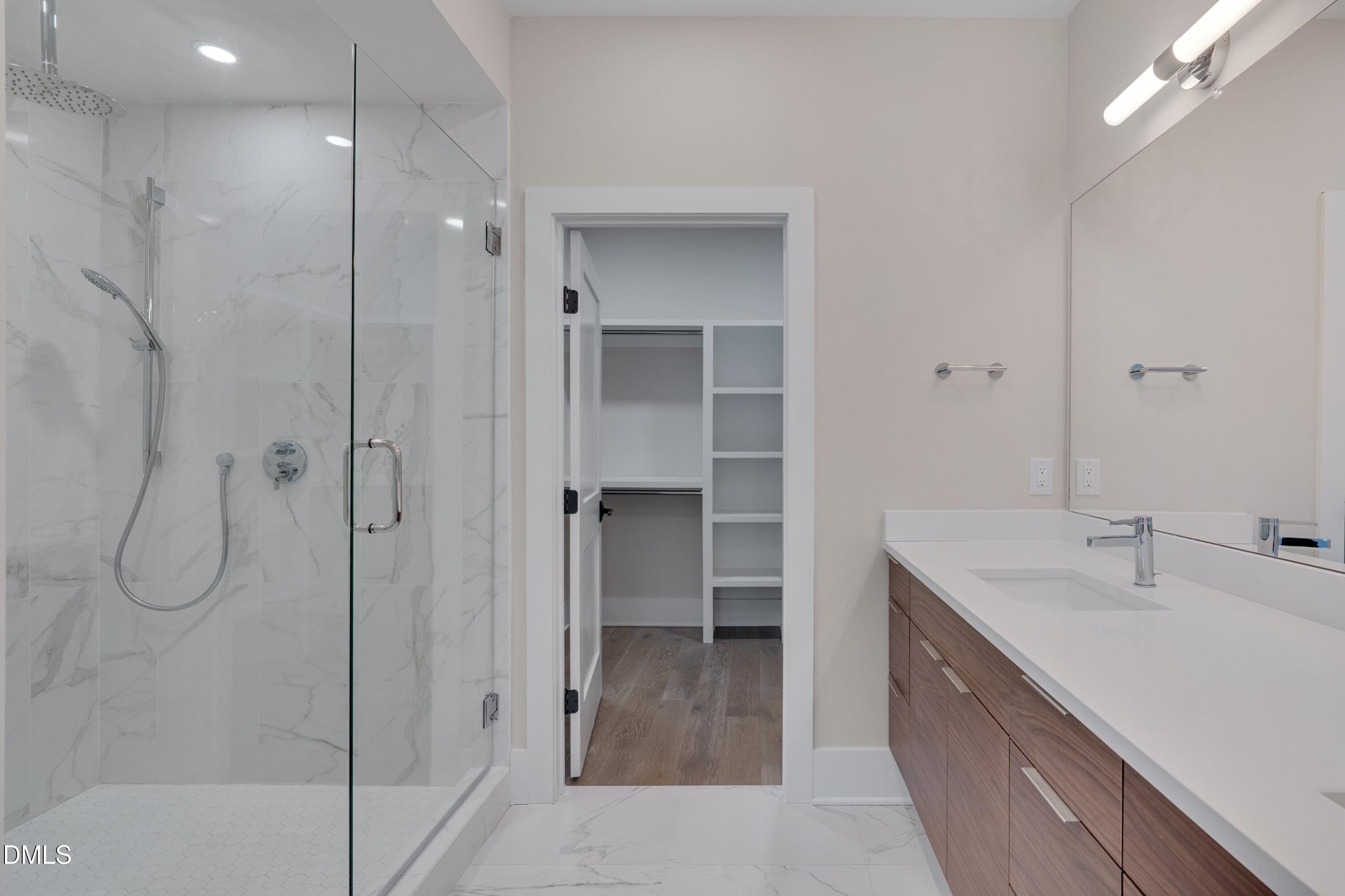 1014 Manor Way Durham, NC 27701 - Photo 27 of 38 a bathroom with a shower sink and mirror