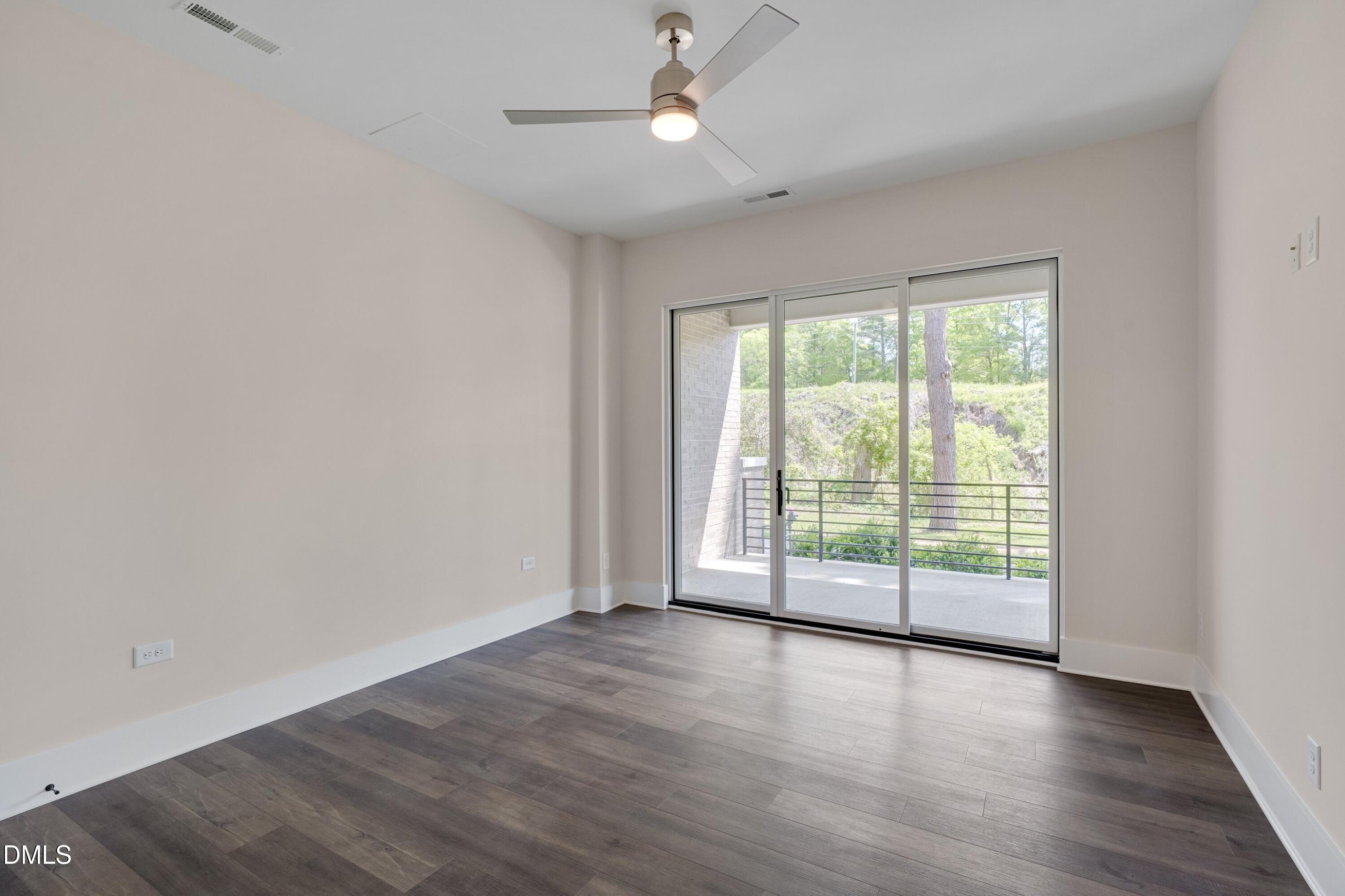 1014 Manor Way Durham, NC 27701 - Photo 5 of 38 an empty room with wooden floor and balcony