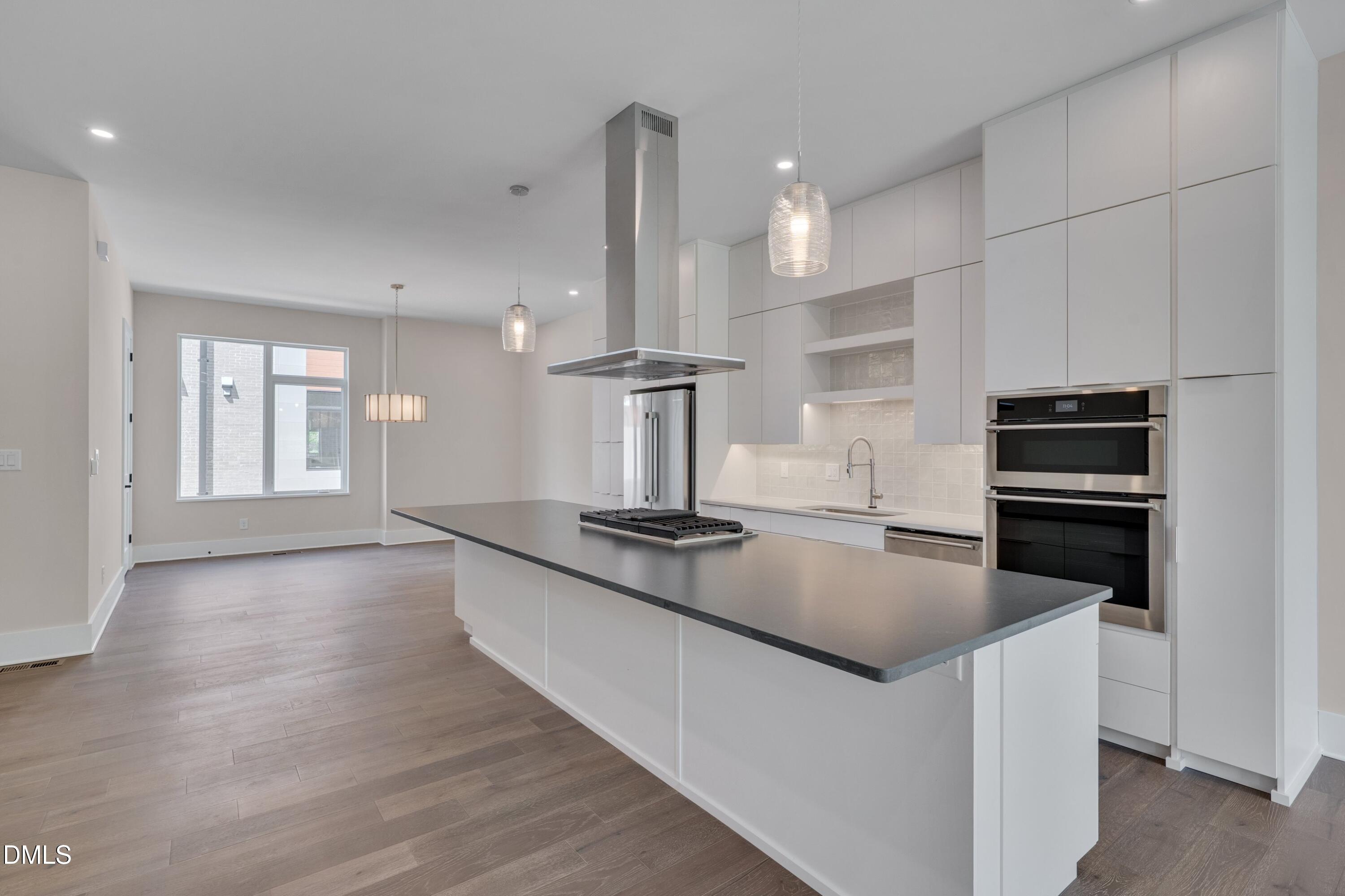 1014 Manor Way Durham, NC 27701 - Photo 10 of 38 a kitchen with stainless steel appliances granite countertop a sink stove and refrigerator