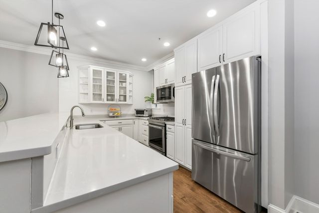 a kitchen with refrigerator cabinets and a sink