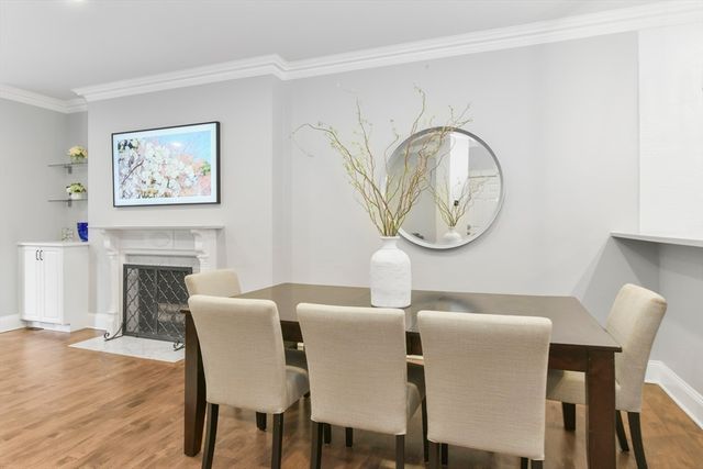 a view of a dining room with furniture wooden floor and a fireplace