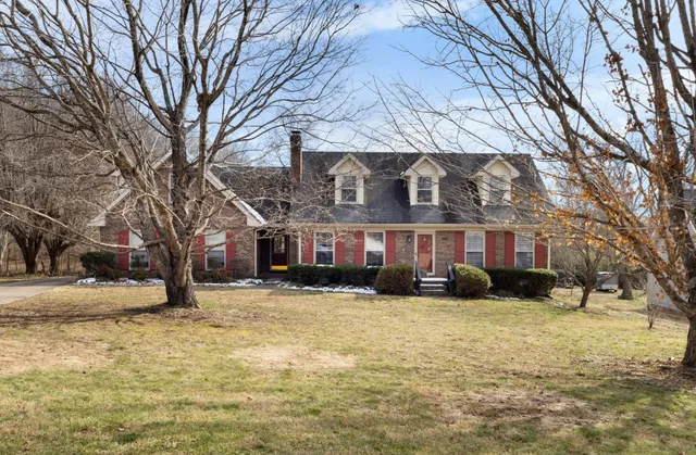 a view of a building with a yard covered with snow in front of house