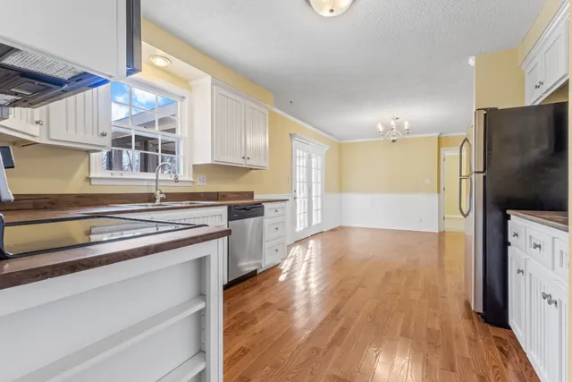a kitchen with stainless steel appliances granite countertop a refrigerator and a stove top oven