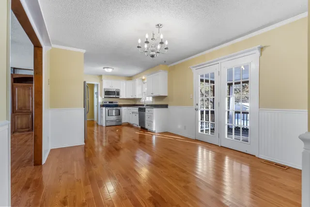 a view of a kitchen with wooden floor and a kitchen