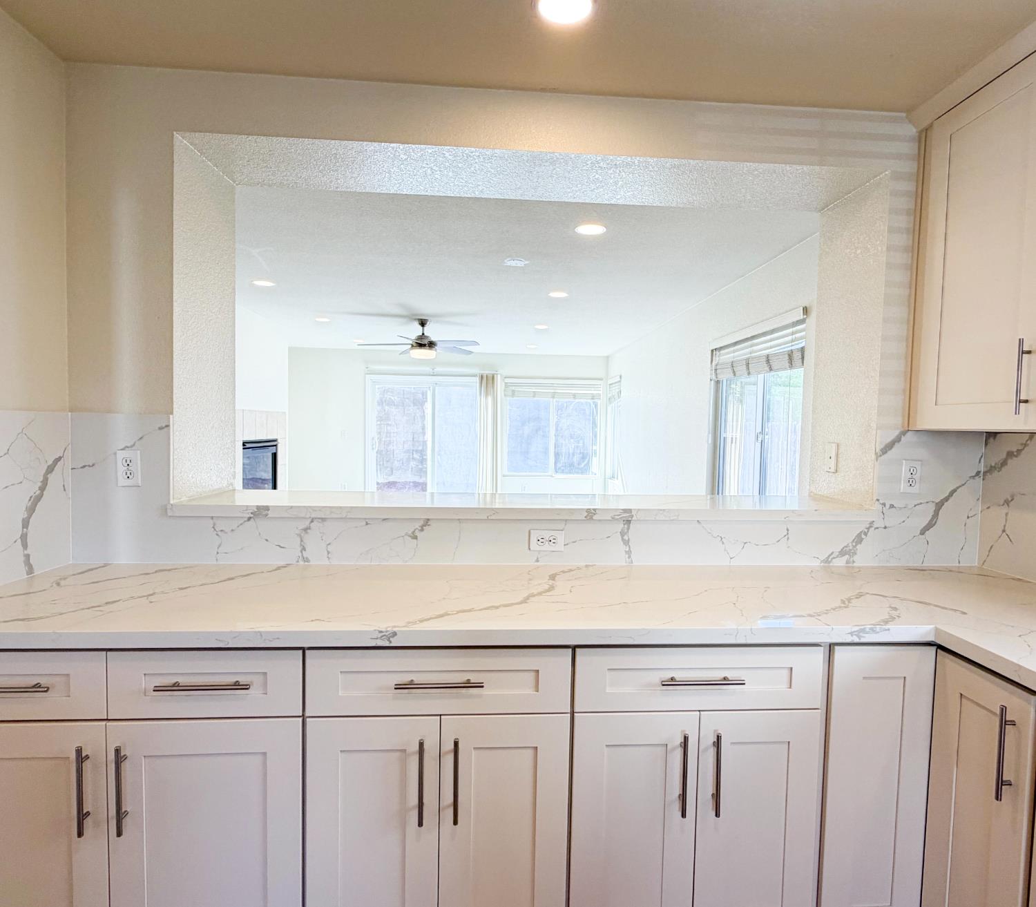 7948 Cavalier Way Sacramento, CA 95832 - Photo 5 of 17 a kitchen with granite countertop white cabinets and a sink