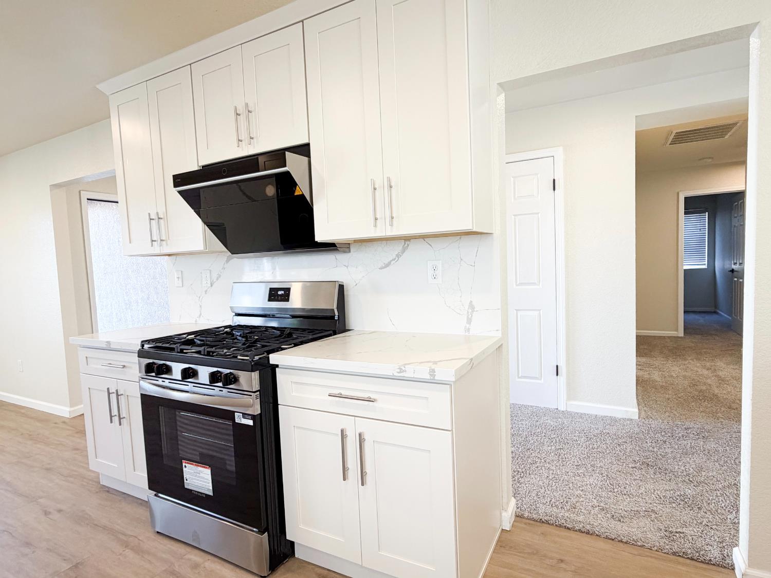 7948 Cavalier Way Sacramento, CA 95832 - Photo 6 of 17 a kitchen with granite countertop a stove and a sink