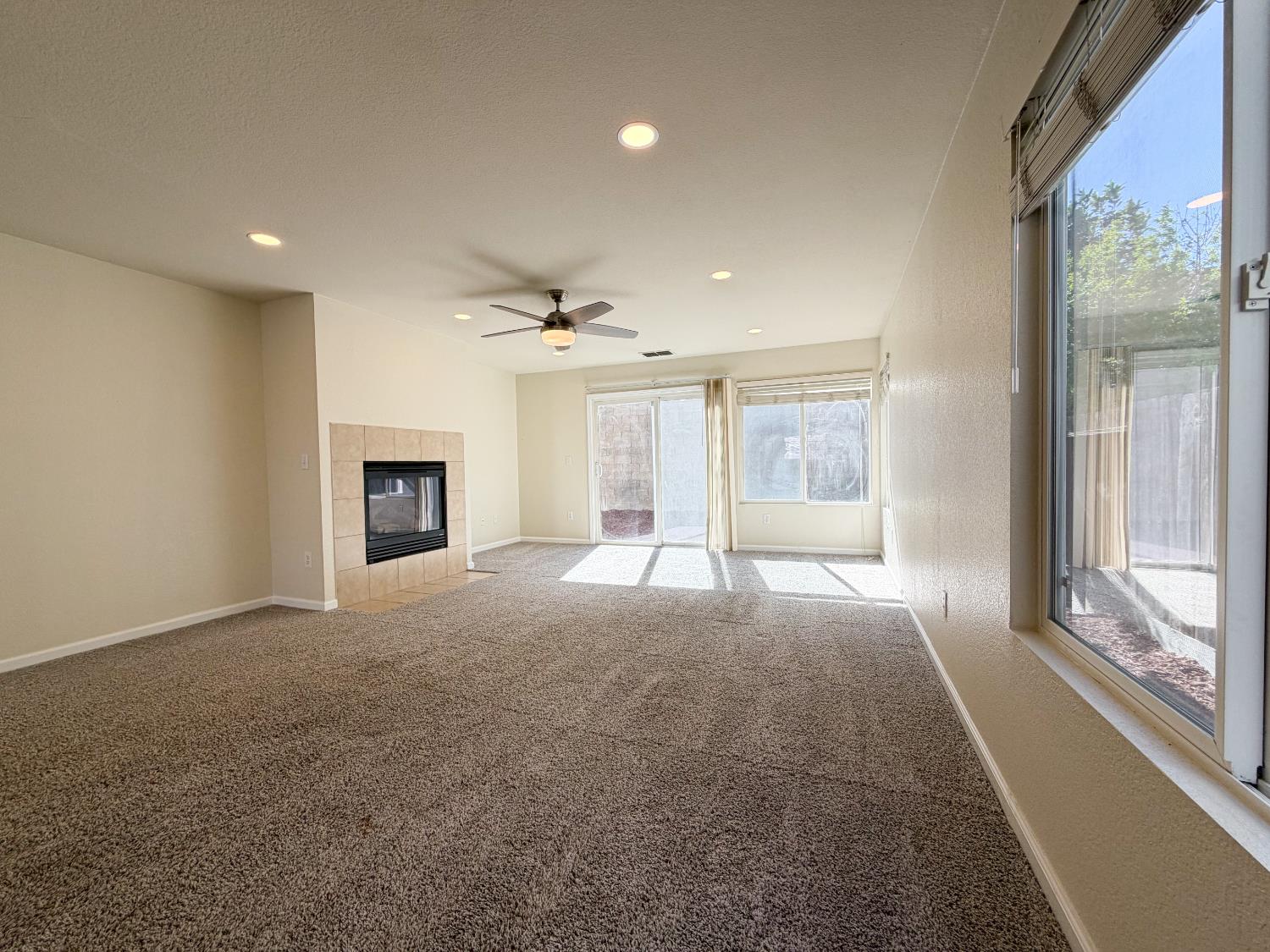 7948 Cavalier Way Sacramento, CA 95832 - Photo 7 of 17 a big room with windows and a fireplace