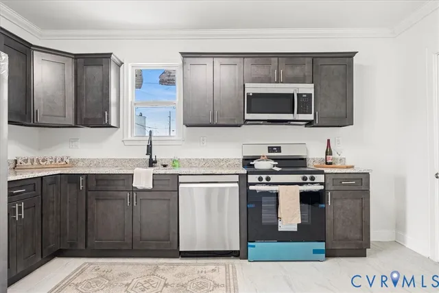a kitchen with stainless steel appliances wooden cabinets and a sink