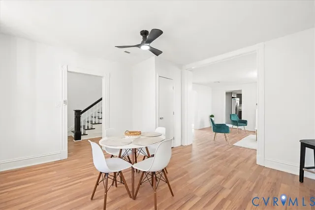 a view of a dining room with furniture and wooden floor