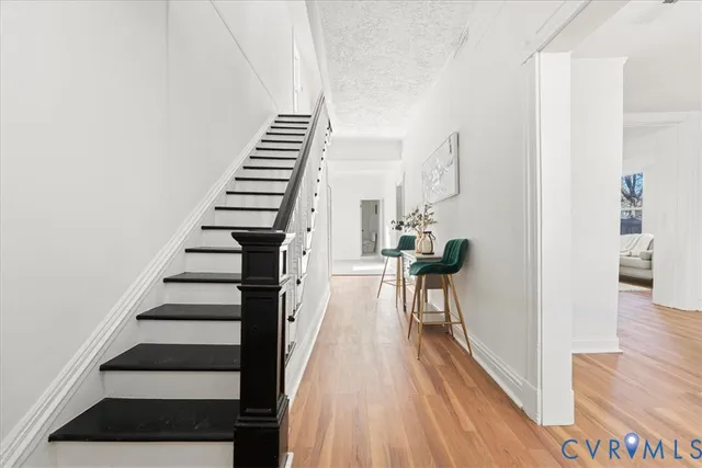 a view of entryway and hall with wooden floor