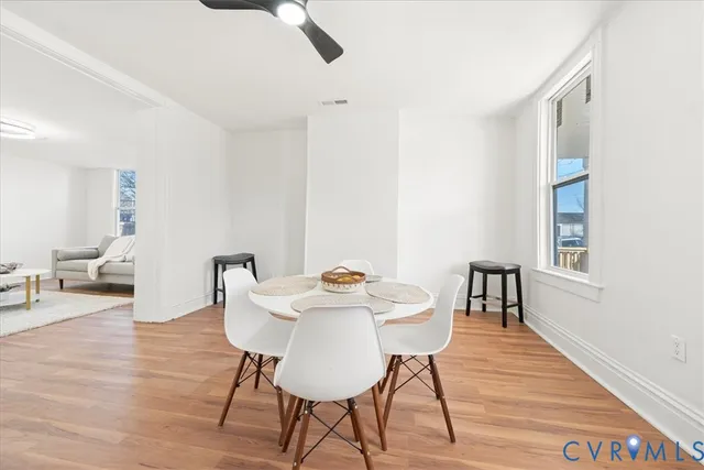 a view of a dining room with furniture and wooden floor