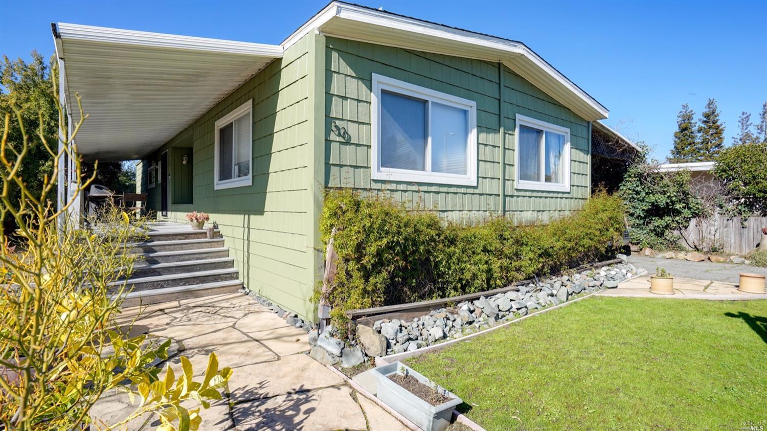 30 Yosemite Road, Unit 30 San Rafael, CA 94903 - Photo 1 of 1 a front view of a house with garden