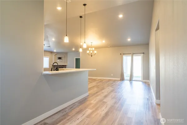 a view of a kitchen with sink and wooden floor