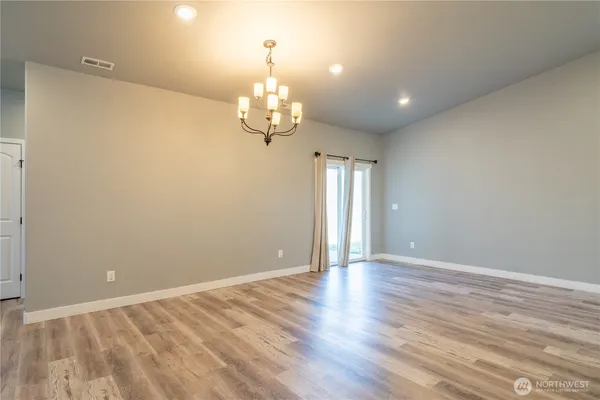 a spacious bathroom with a granite countertop sink a toilet a shower and a mirror