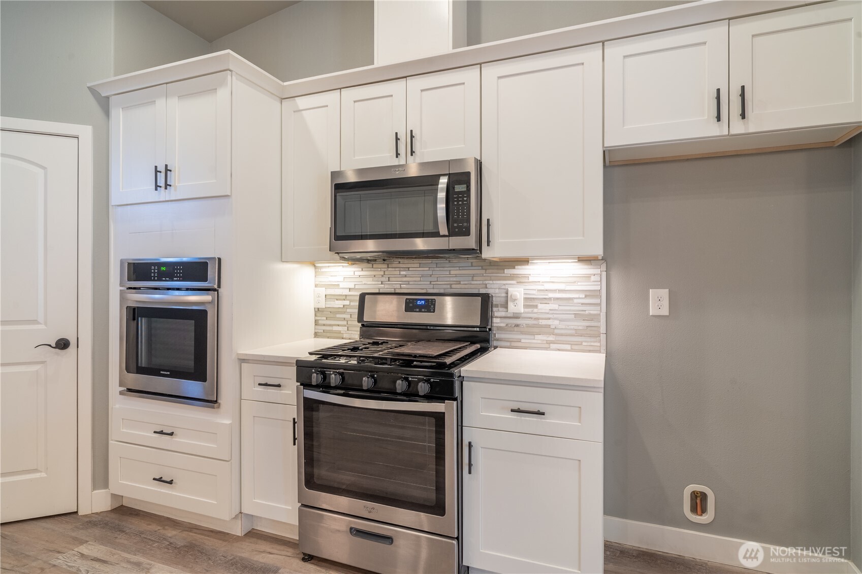 352 East Davis Street Connell, WA 99326 - Photo 17 of 40 a kitchen with white cabinets and stainless steel appliances