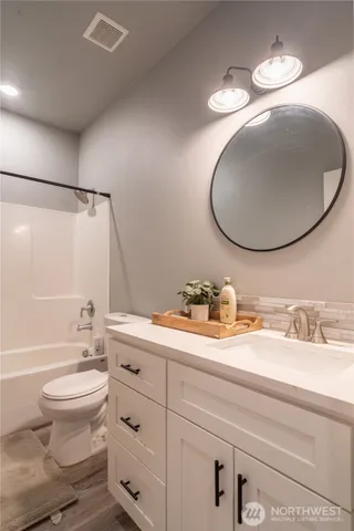 a view of a room with a hanging light and closet
