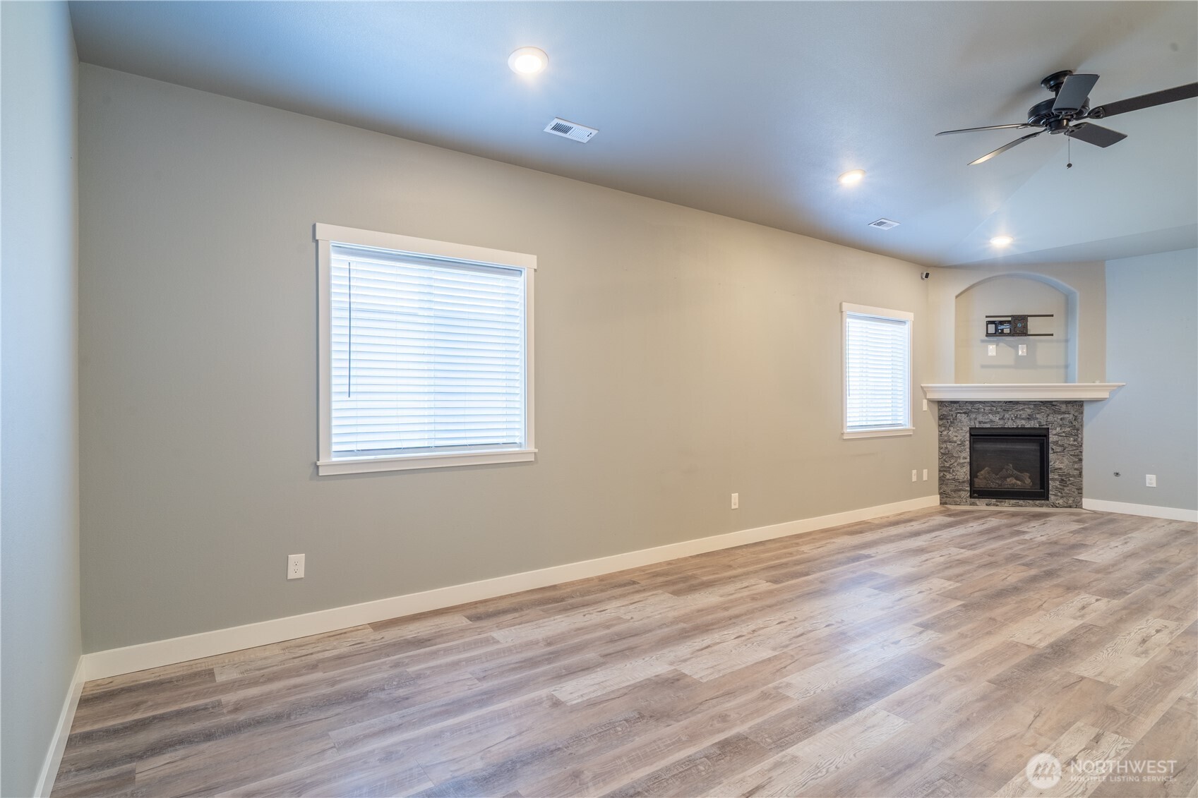352 East Davis Street Connell, WA 99326 - Photo 19 of 40 an empty room with windows fireplace and wooden floor