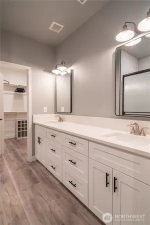 a en suite bathroom with a sink and a large mirror