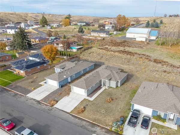 an aerial view of residential houses with outdoor space
