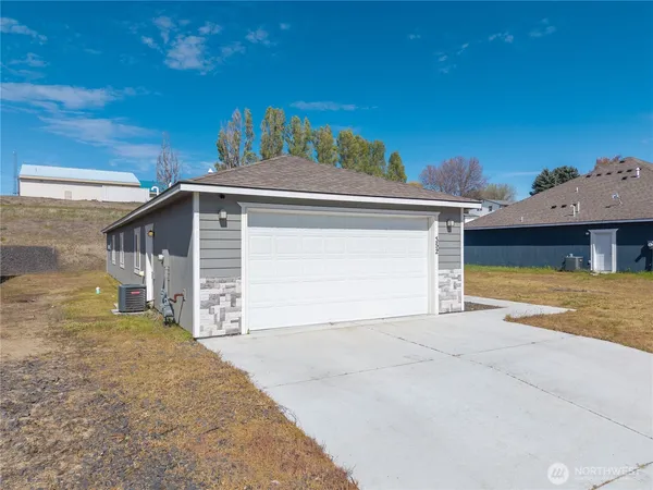 a front view of a house with a yard and garage