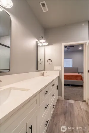a bathroom with a double vanity sink and mirror