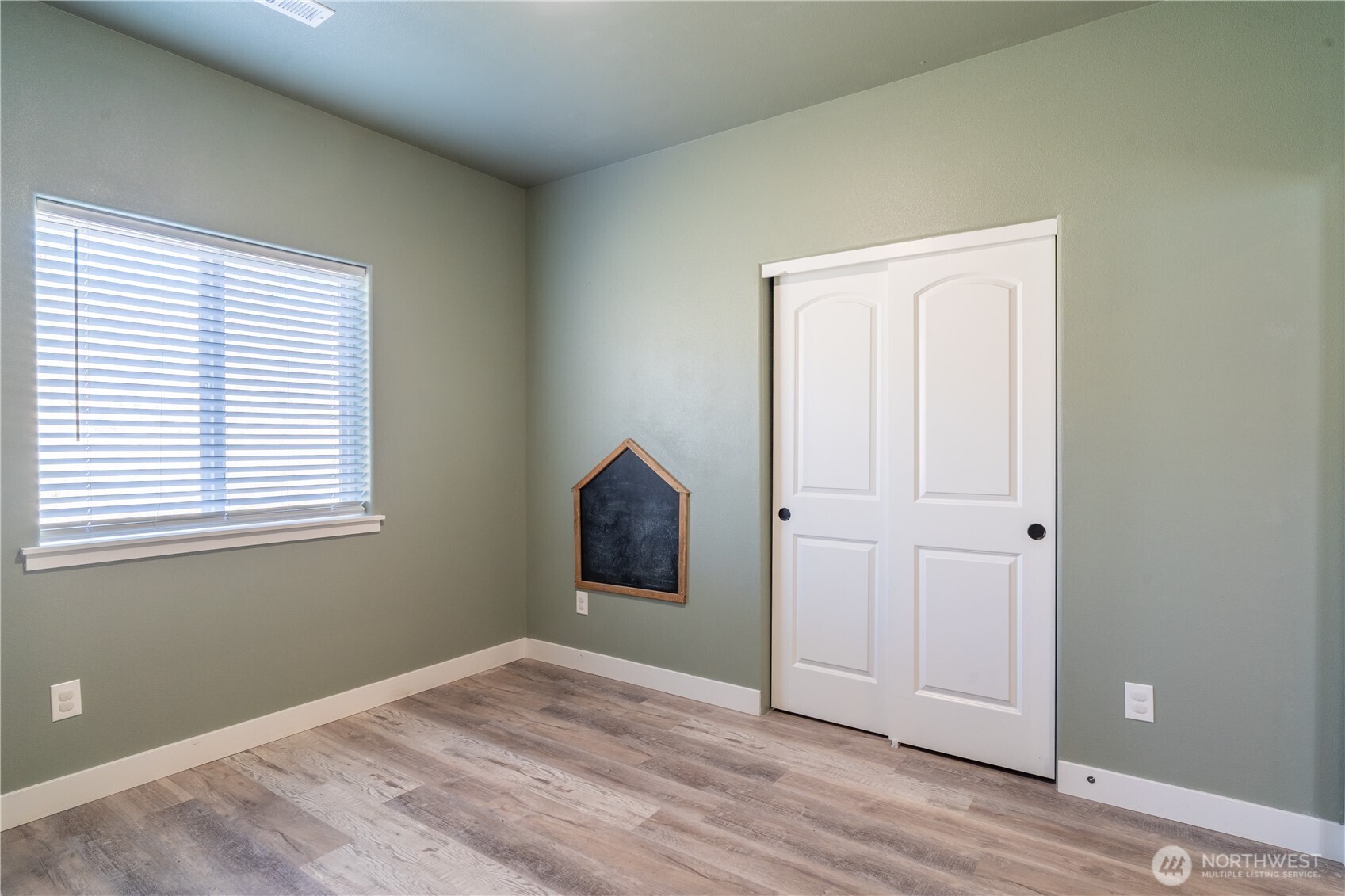 352 East Davis Street Connell, WA 99326 - Photo 32 of 40 a view of an empty room with wooden floor and a window