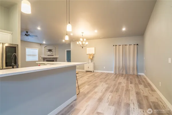 a living room with kitchen island granite countertop furniture and a fireplace