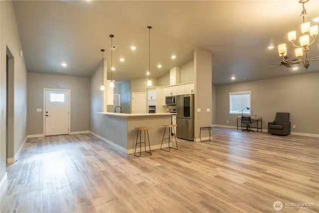a view of a kitchen with a sink and a wooden floor