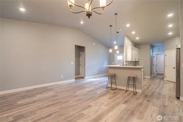 a view of a kitchen with a sink and a wooden floor