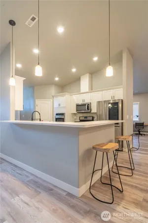 a kitchen with counter top space cabinets and appliances