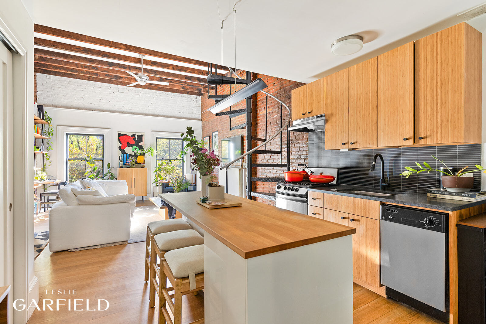 485 West 22nd Street Manhattan, NY 10011 - Photo 3 of 20 a living room with stainless steel appliances kitchen island granite countertop a sink and cabinets