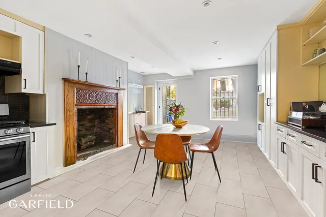 a dining room with furniture a fireplace and wooden floor
