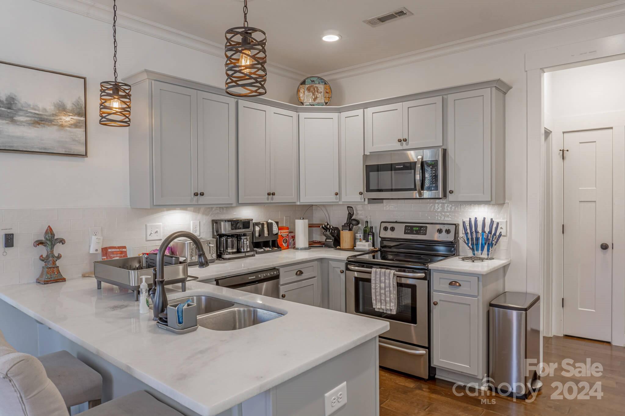 305 Lowndes Hill Road Greenville, SC 29607 - Photo 8 of 20 a kitchen with sink a microwave and cabinets