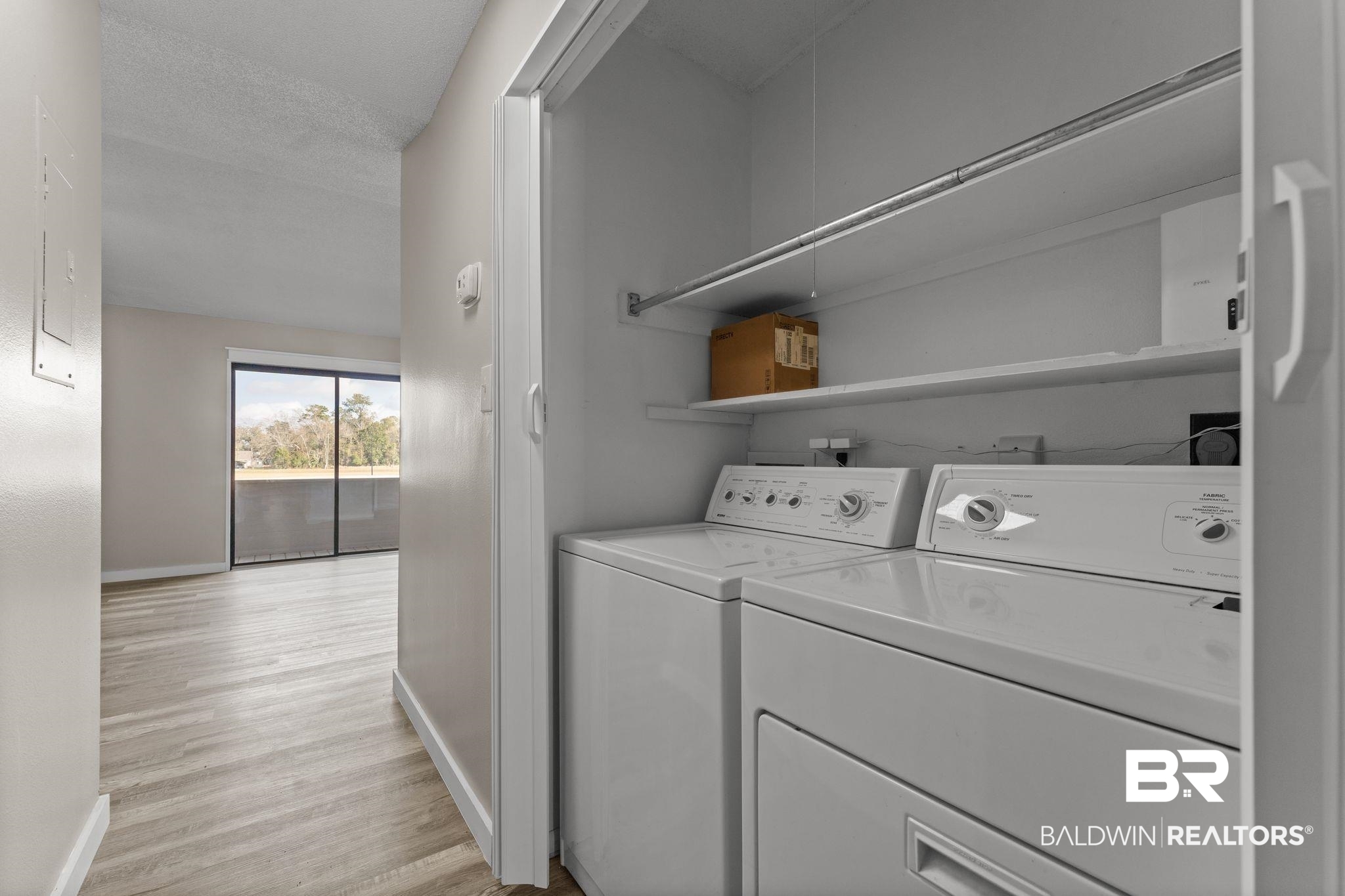128 West Satsuma Avenue, Unit 128 Foley, AL 36535 - Photo 27 of 41 Laundry area with washing machine and dryer and light wood finished floors