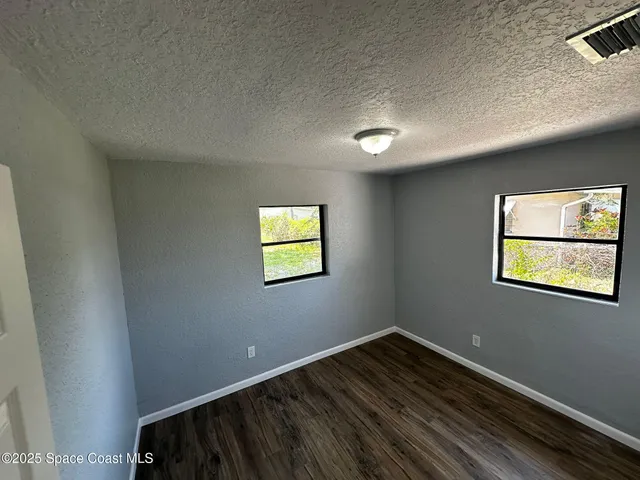 a view of empty room with windows