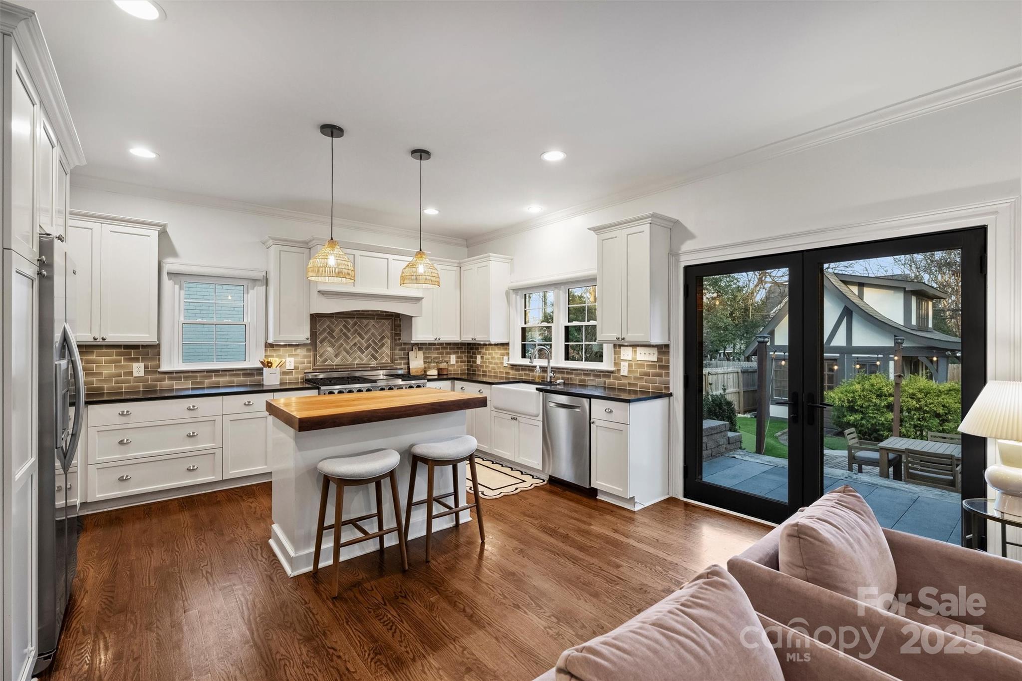 1914 Club Road Charlotte, NC 28205 - Photo 12 of 40 a kitchen with stainless steel appliances granite countertop a refrigerator a sink dishwasher a stove and white countertops with wooden floor
