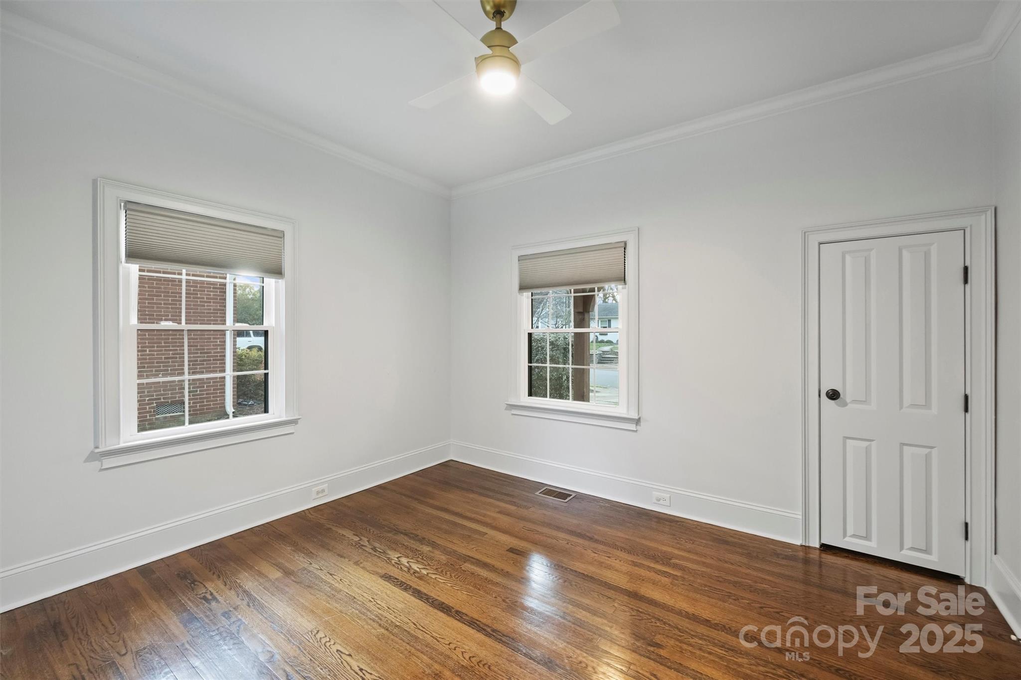 1914 Club Road Charlotte, NC 28205 - Photo 26 of 40 an empty room with wooden floor and windows