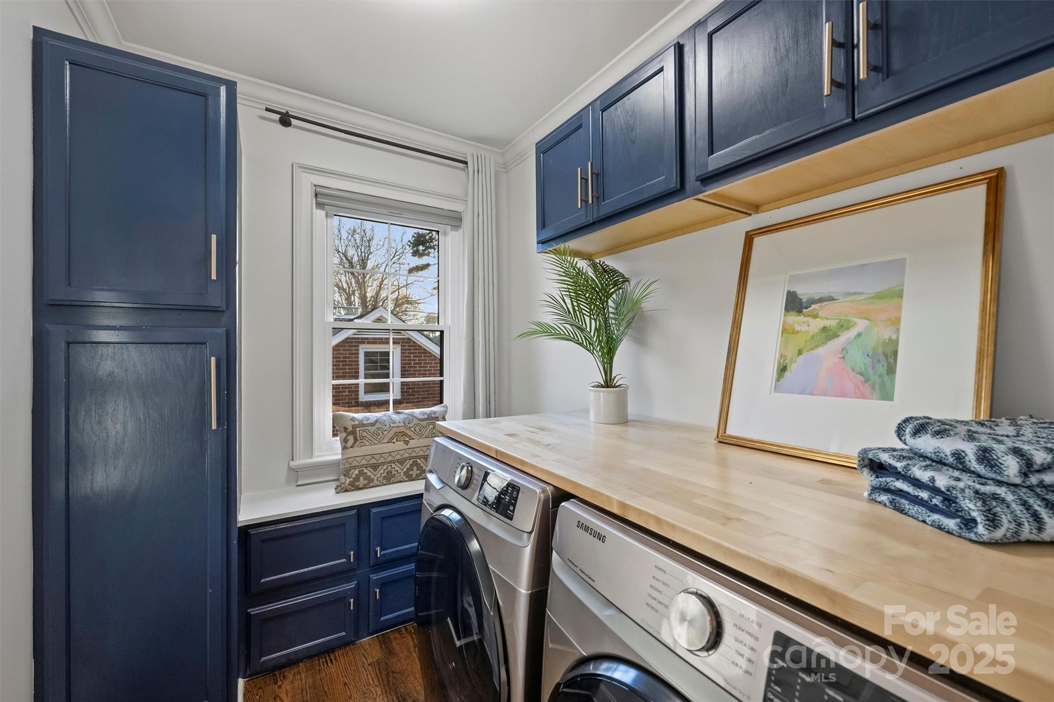 1914 Club Road Charlotte, NC 28205 - Photo 29 of 40 a view of kitchen island with cabinets and wooden floor