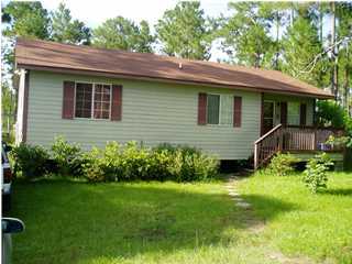 186 East Nursery Road Santa Rosa Beach, FL 32459 - Photo 1 of 1 a view of backyard with potted plants and a bench