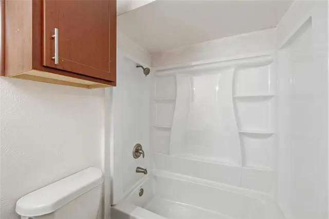 a bathroom with a toilet and a bathtub