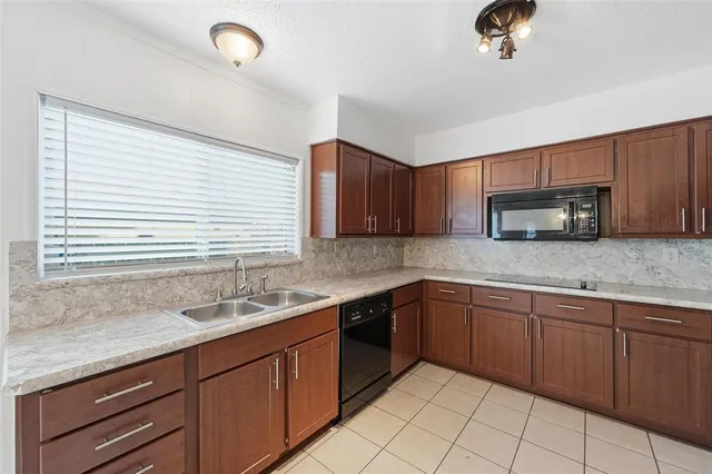 a kitchen with stainless steel appliances granite countertop a sink and a stove