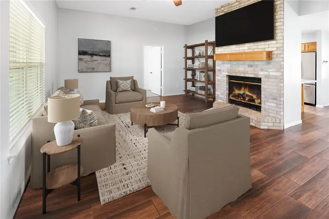 a living room with furniture a flat screen tv and a fireplace