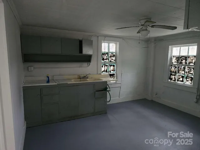 a kitchen with a sink and cabinets