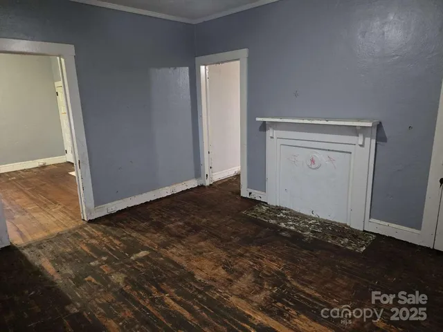 a view of a room with wooden floor
