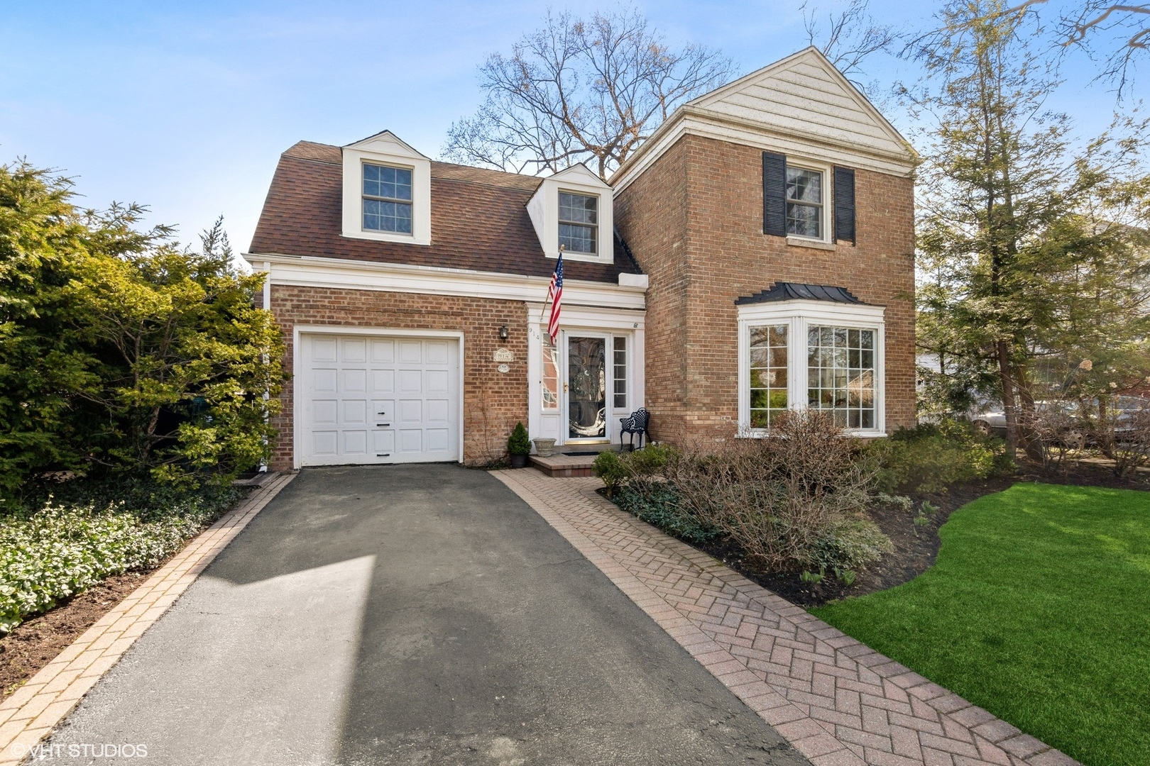 914 Cherokee Road Wilmette, IL 60091 - Photo 1 of 24 a front view of a house with a yard and garage