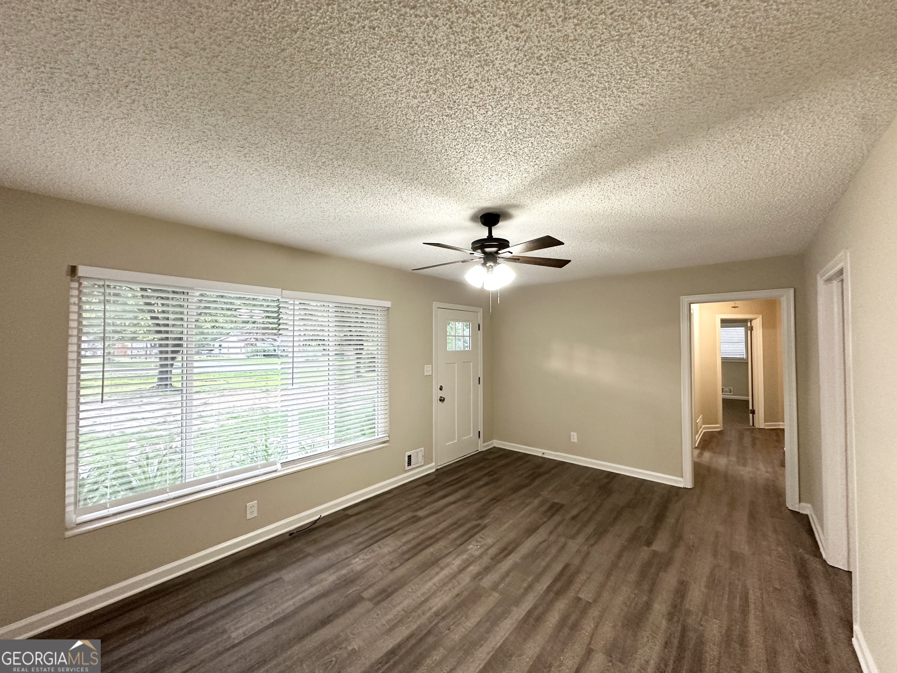 4385 Midway Road Douglasville, GA 30134 - Photo 4 of 12 a view of an empty room with a window and wooden floor