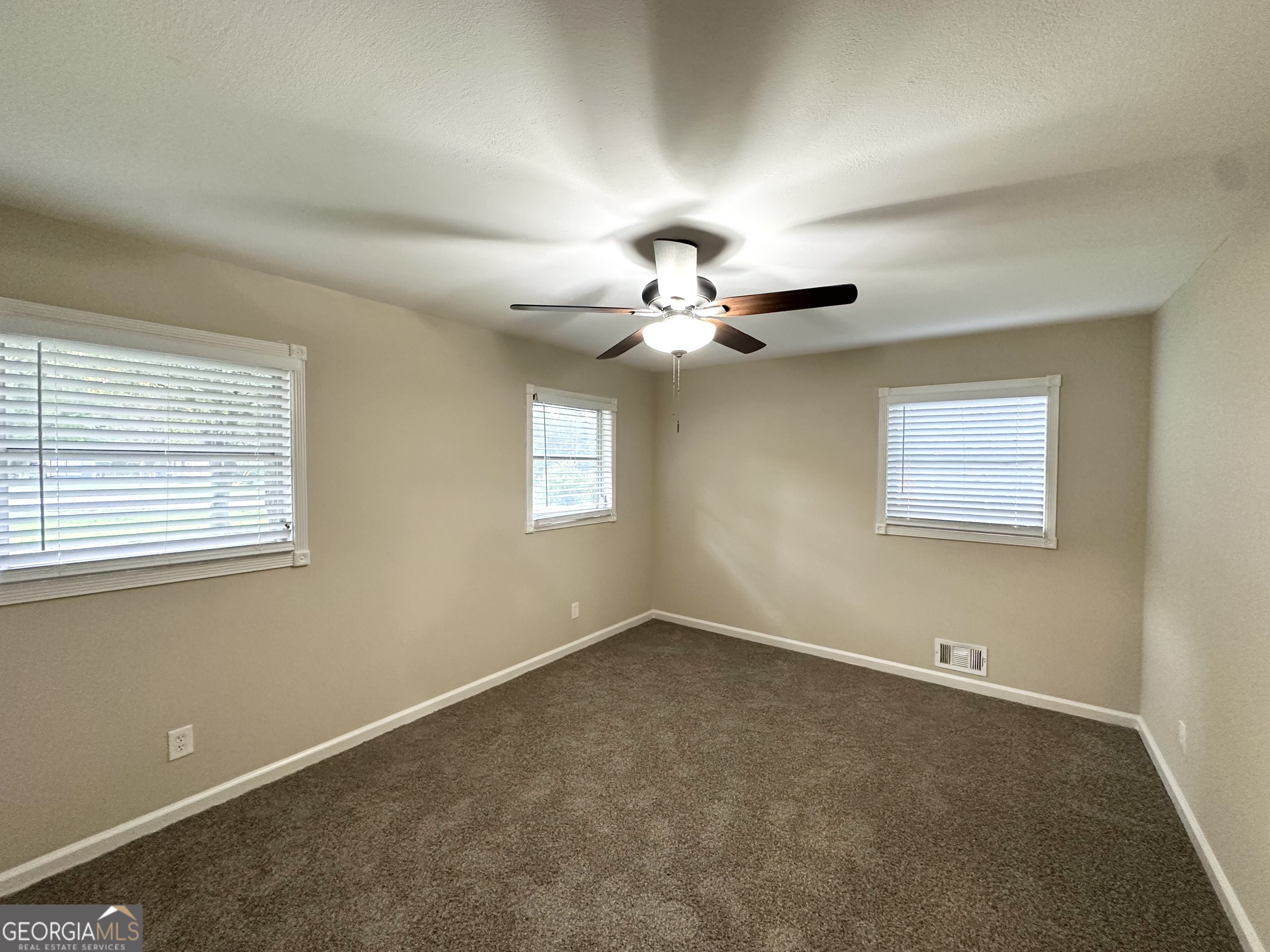 4385 Midway Road Douglasville, GA 30134 - Photo 8 of 12 a view of a livingroom with a ceiling fan and window