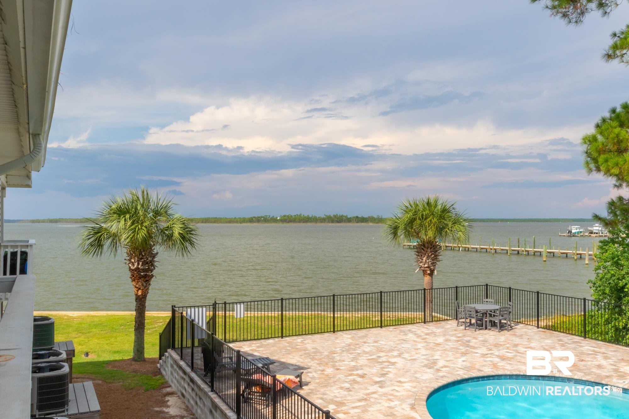 25925 -C Canal Road, Unit 203 Orange Beach, AL 36561 - Photo 26 of 57 View of pool featuring a water view, a patio, and central AC
