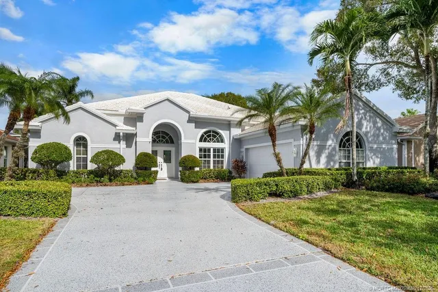 a living room with furniture kitchen view and a large window
