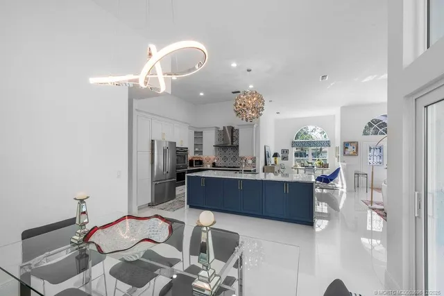 a kitchen with stainless steel appliances granite countertop a refrigerator and a stove